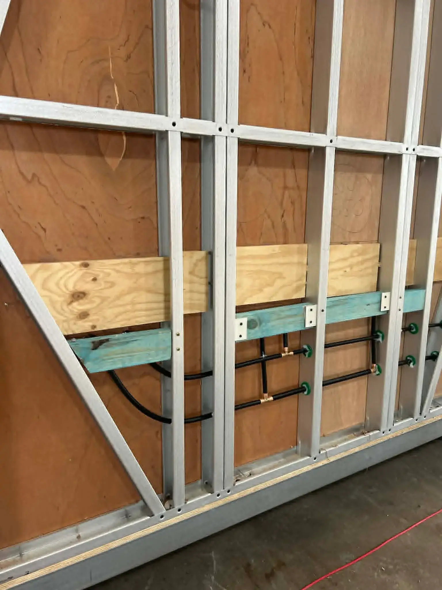 PEX water runs in a steel-framed module wall