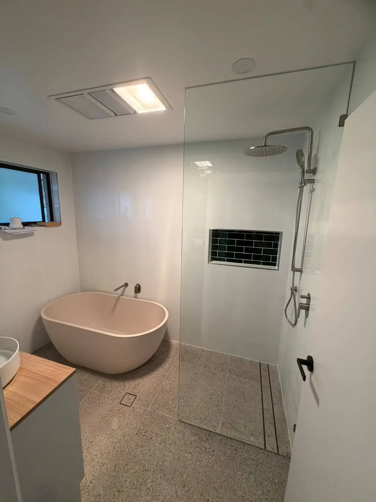 Concrete freestanding bath beside the walk-in shower, Bateau Bay.
