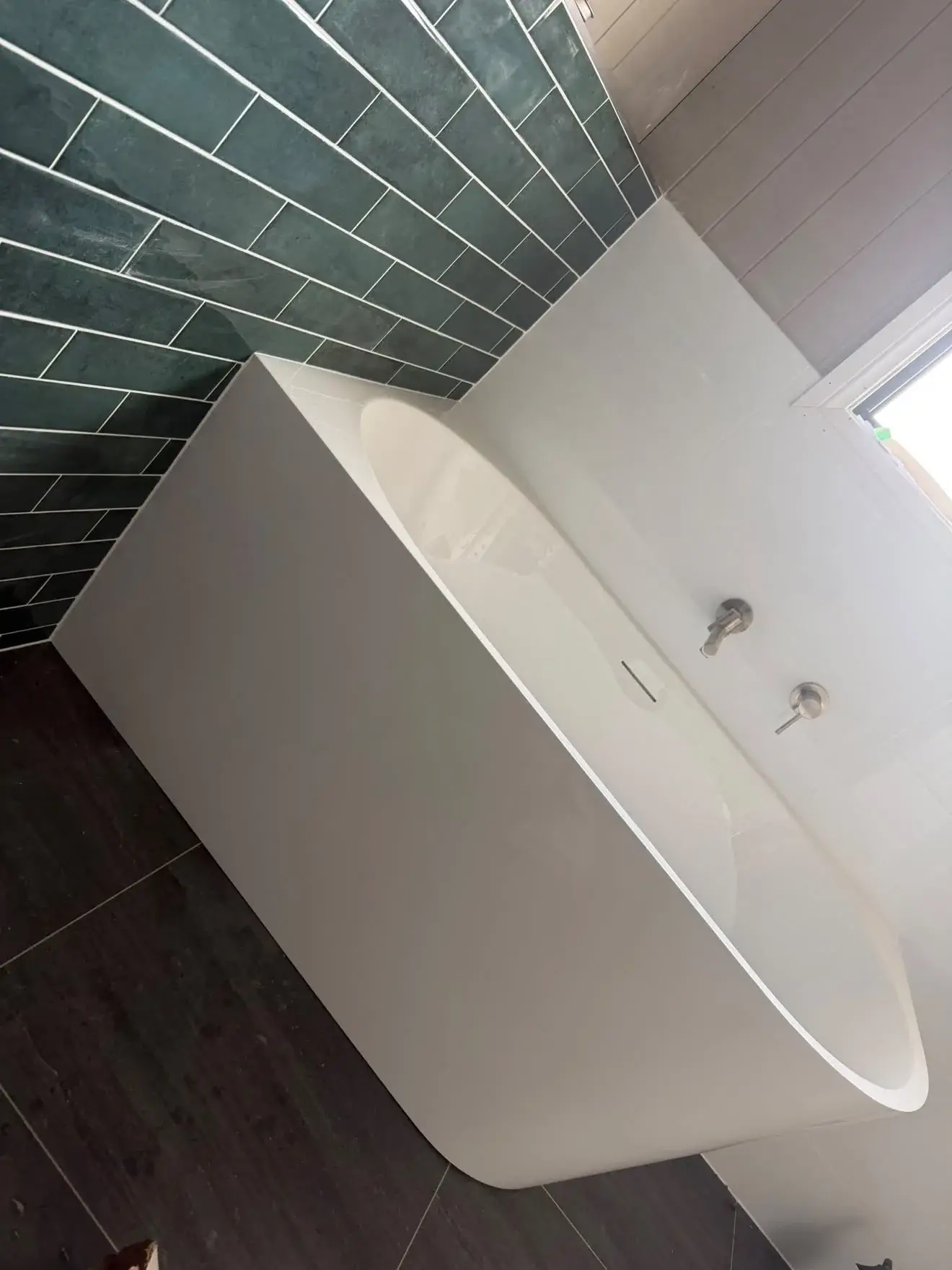 Freestanding bath and wall mixer against green gloss subway tile, Wyee Point.