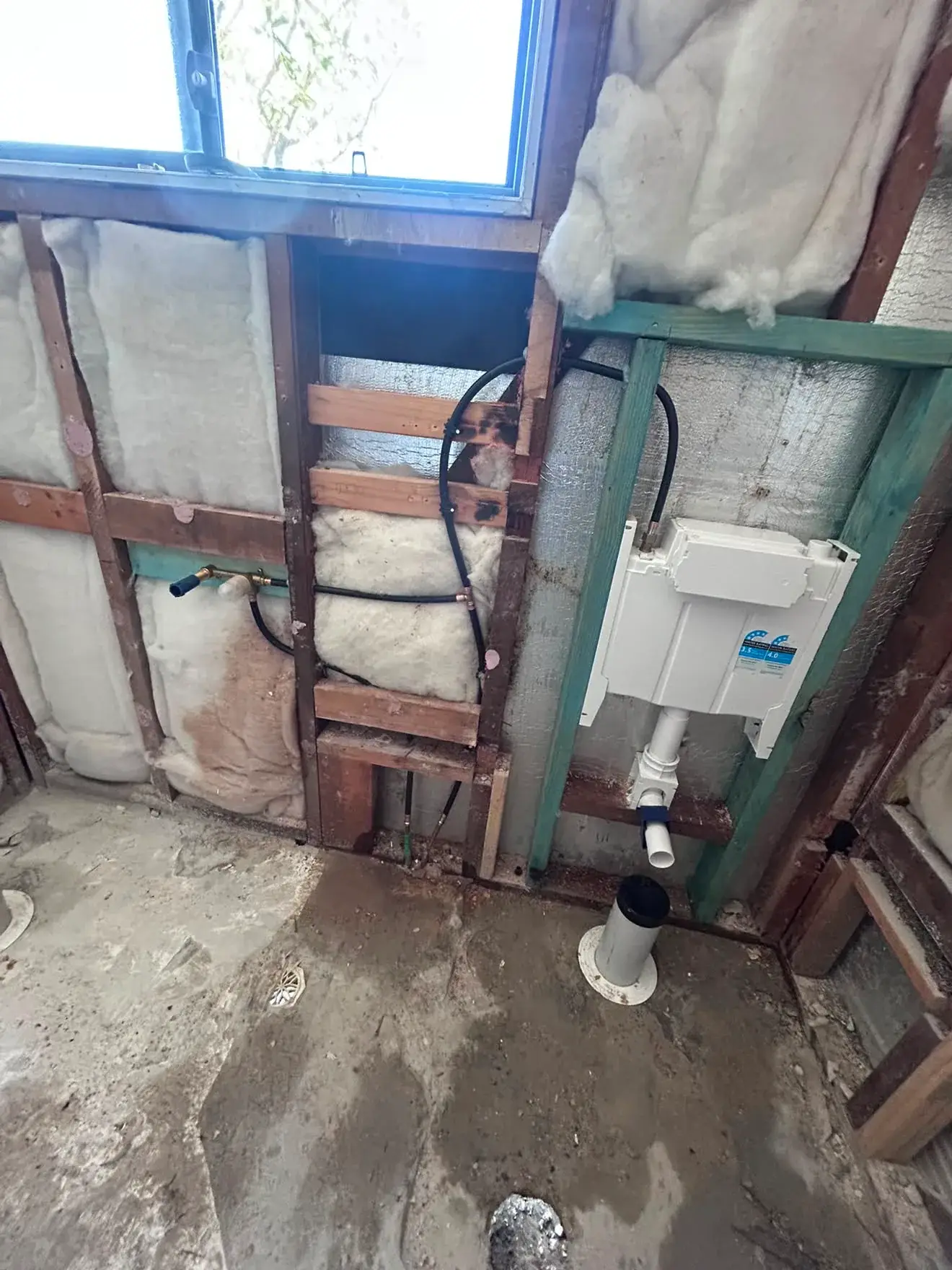 In-wall cistern framed into the stud wall, Gwandalan bathroom.