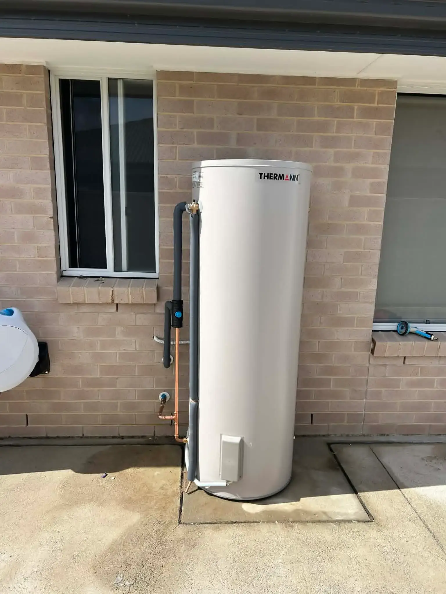 Thermann electric storage on a brick house wall