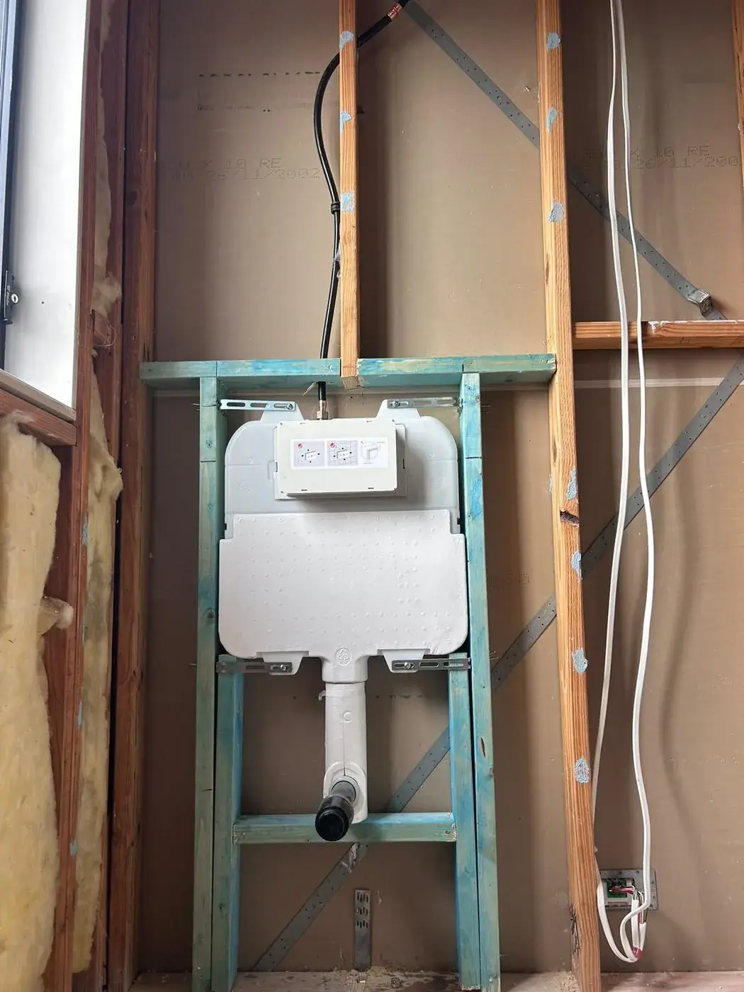In-wall cistern frame fixed into a stud wall before the sheets go on, Woongarrah.