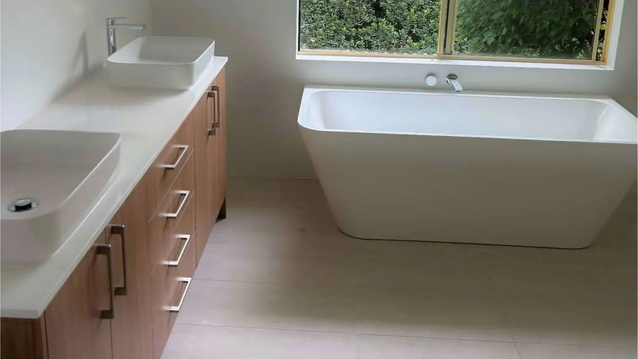 Dual vessel basins, timber vanity and freestanding bath.