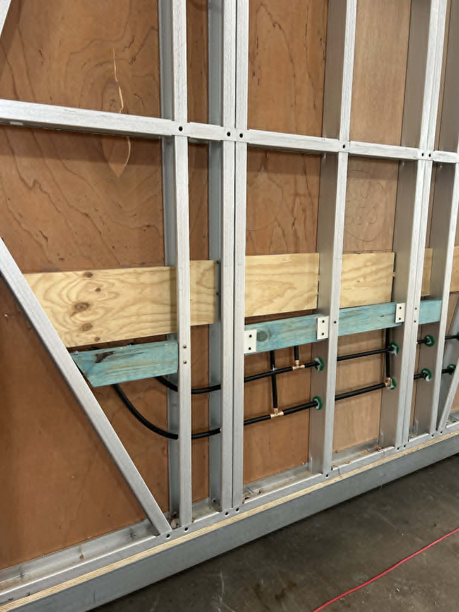 PEX water runs in a steel-framed module wall