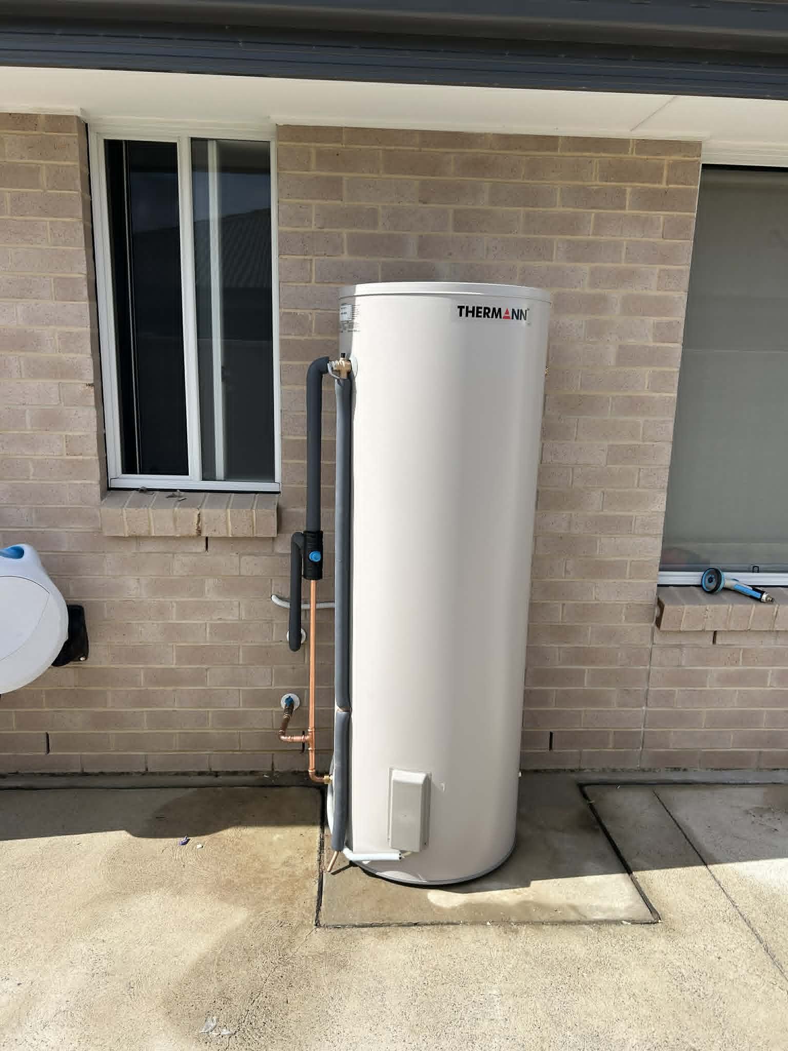 Thermann electric storage on a brick house wall