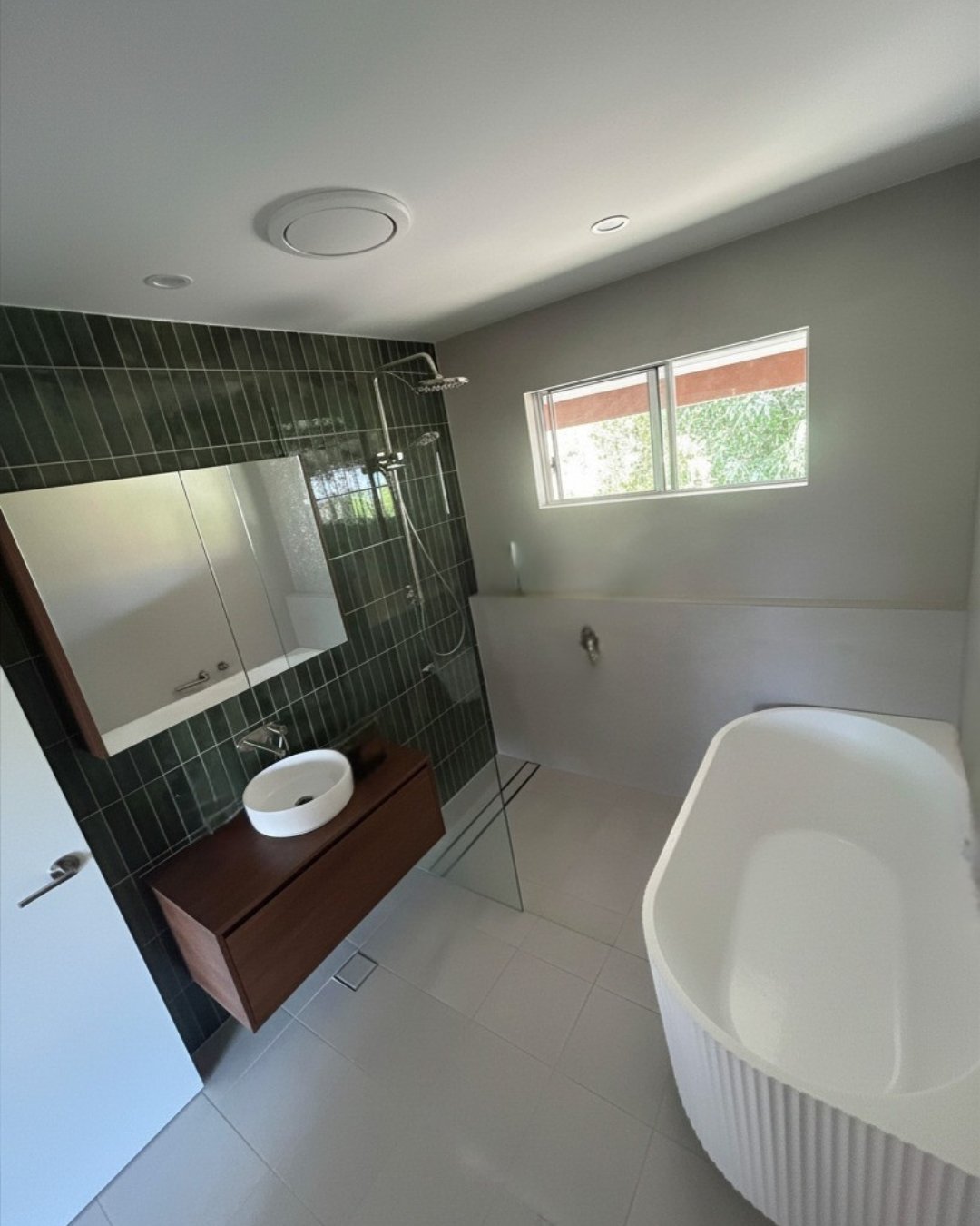 Bathroom, Summerland Point: green tiled shower, timber vanity and fluted freestanding bath.