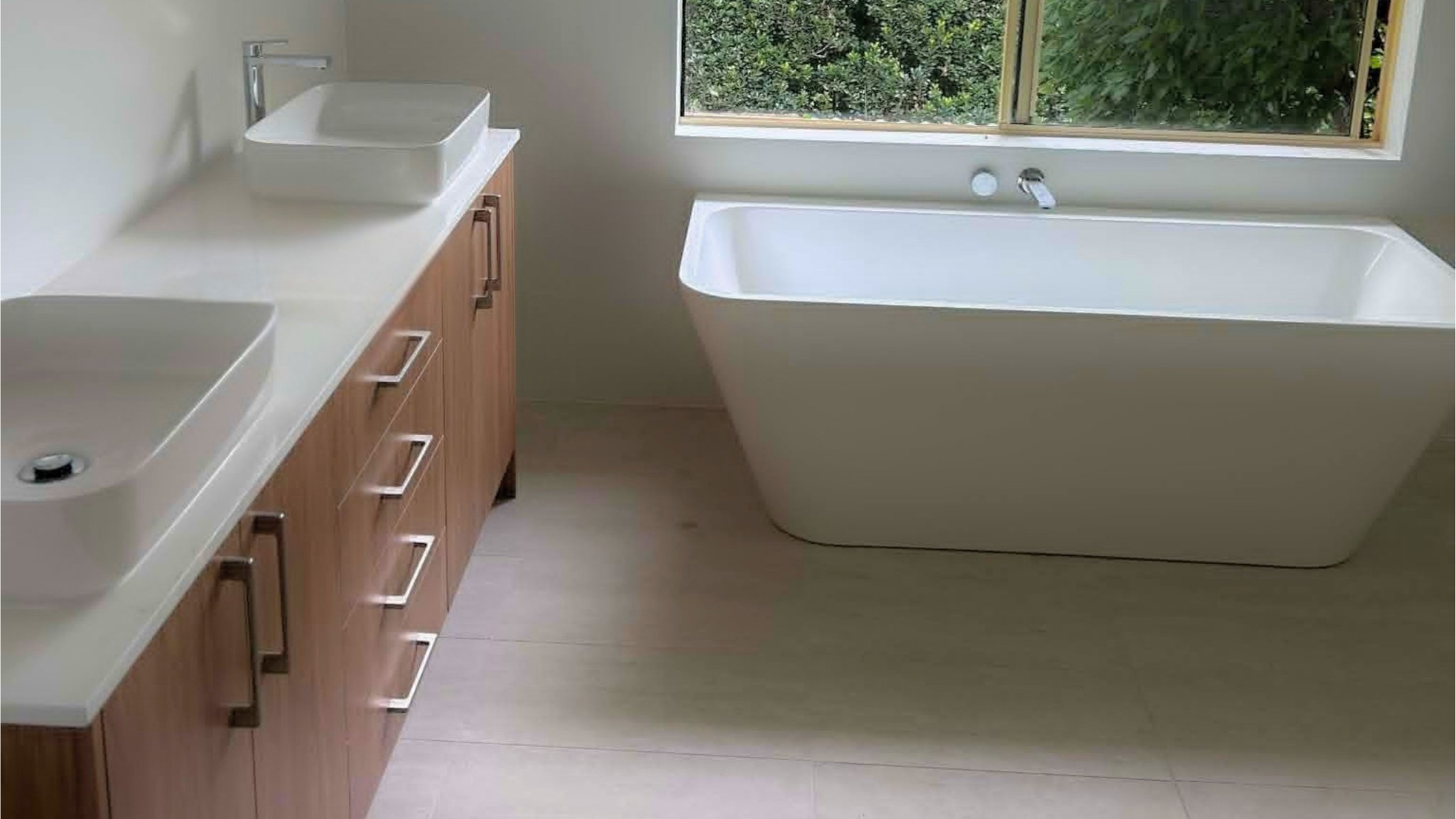 Dual vessel basins, timber vanity and freestanding bath.
