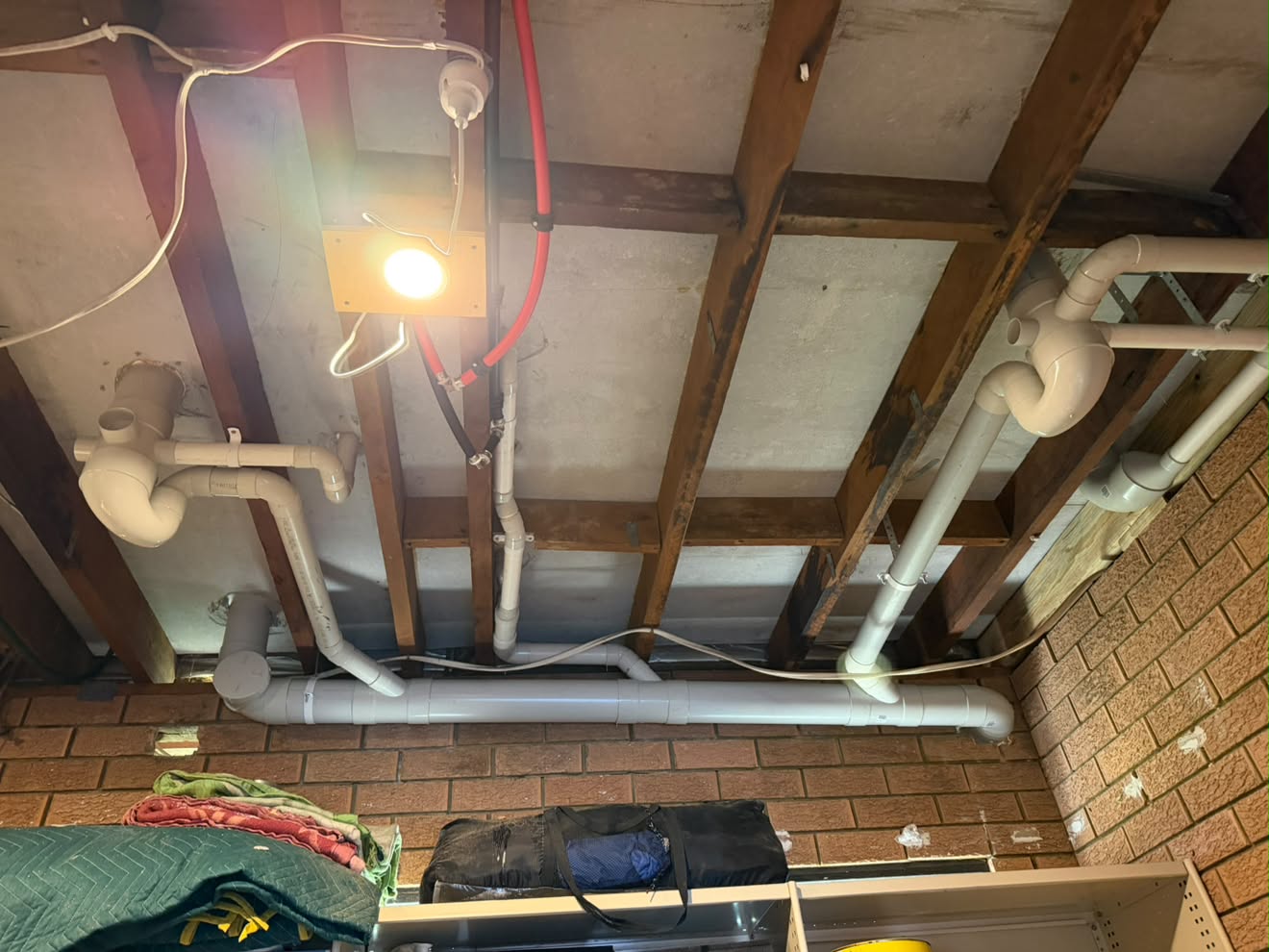 Waste traps and stack drainage under the floor above, set for the rooms being renovated.
