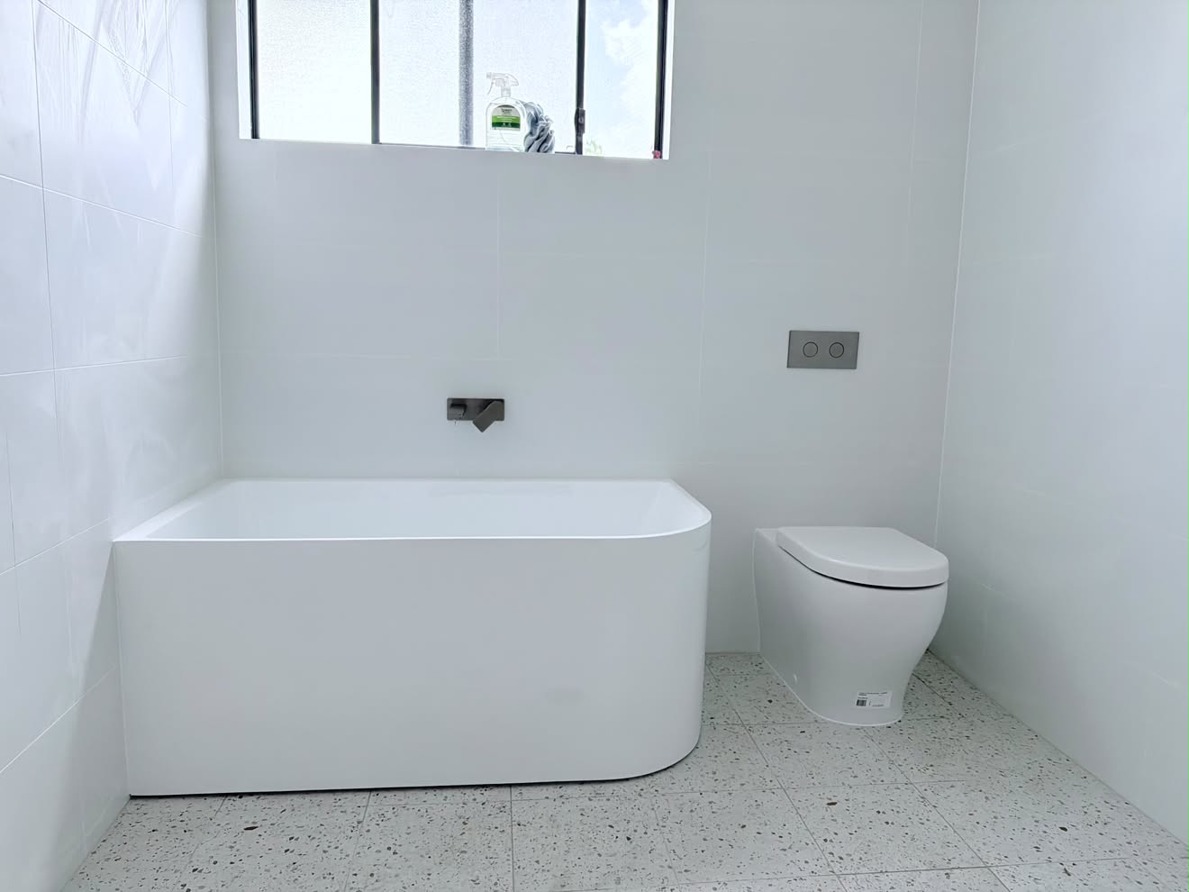 Freestanding bath and black wall spout, Gwandalan.
