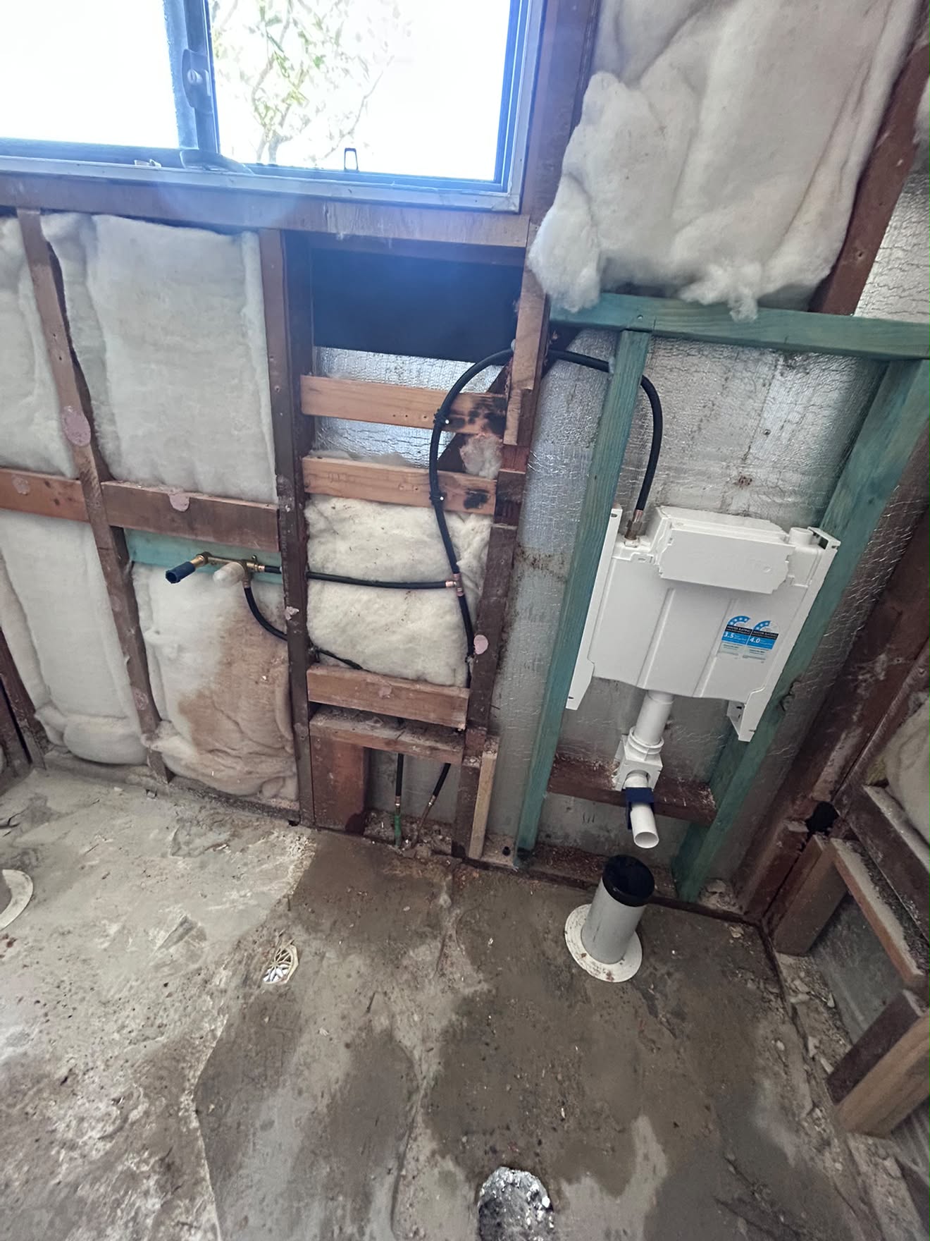 In-wall cistern framed into the stud wall, Gwandalan bathroom.