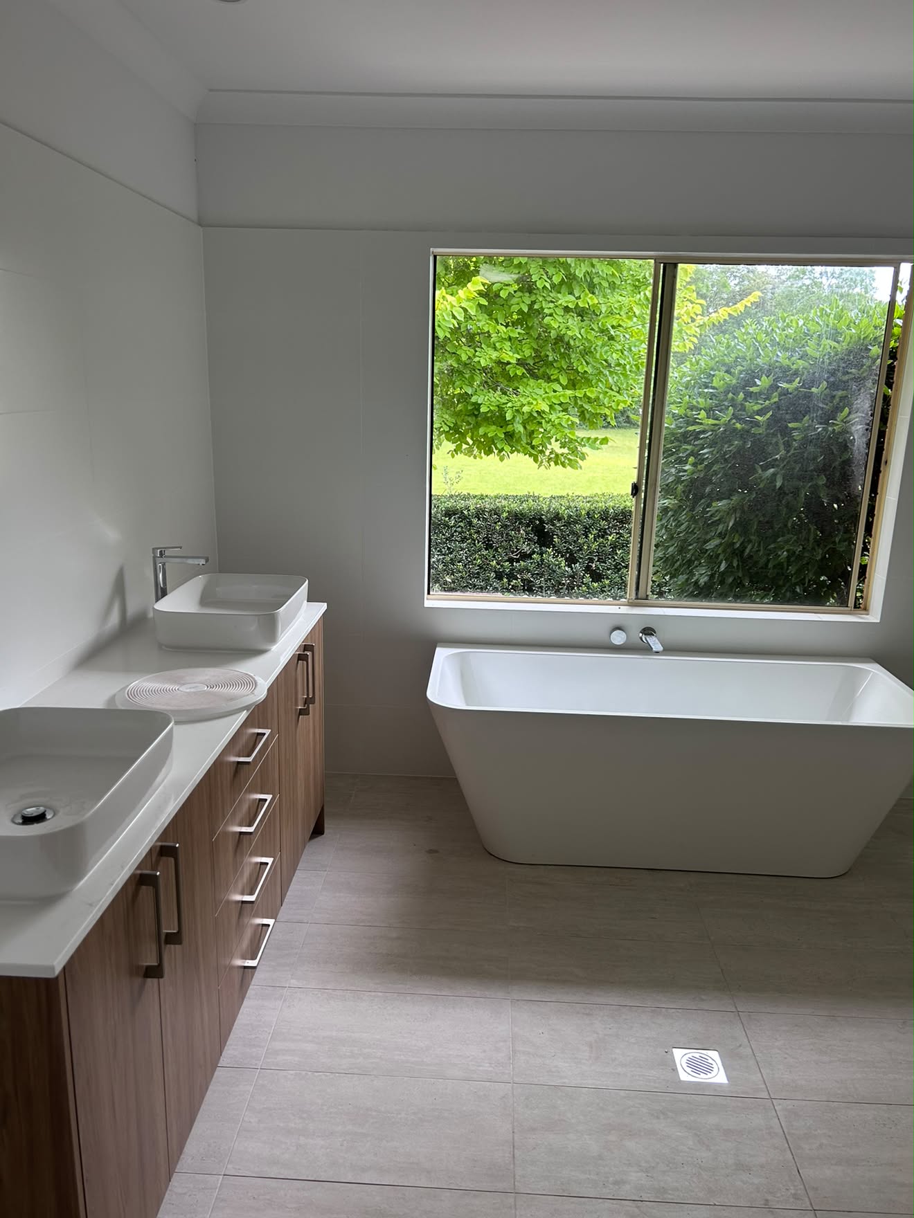 Finished Yarramalong bathroom: double vanity, vessel basins and freestanding bath under the same window