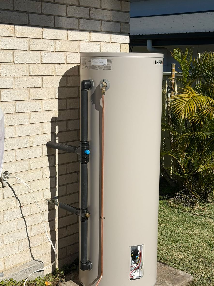 Thermann electric storage on a house wall, tempering valve and relief line fitted.