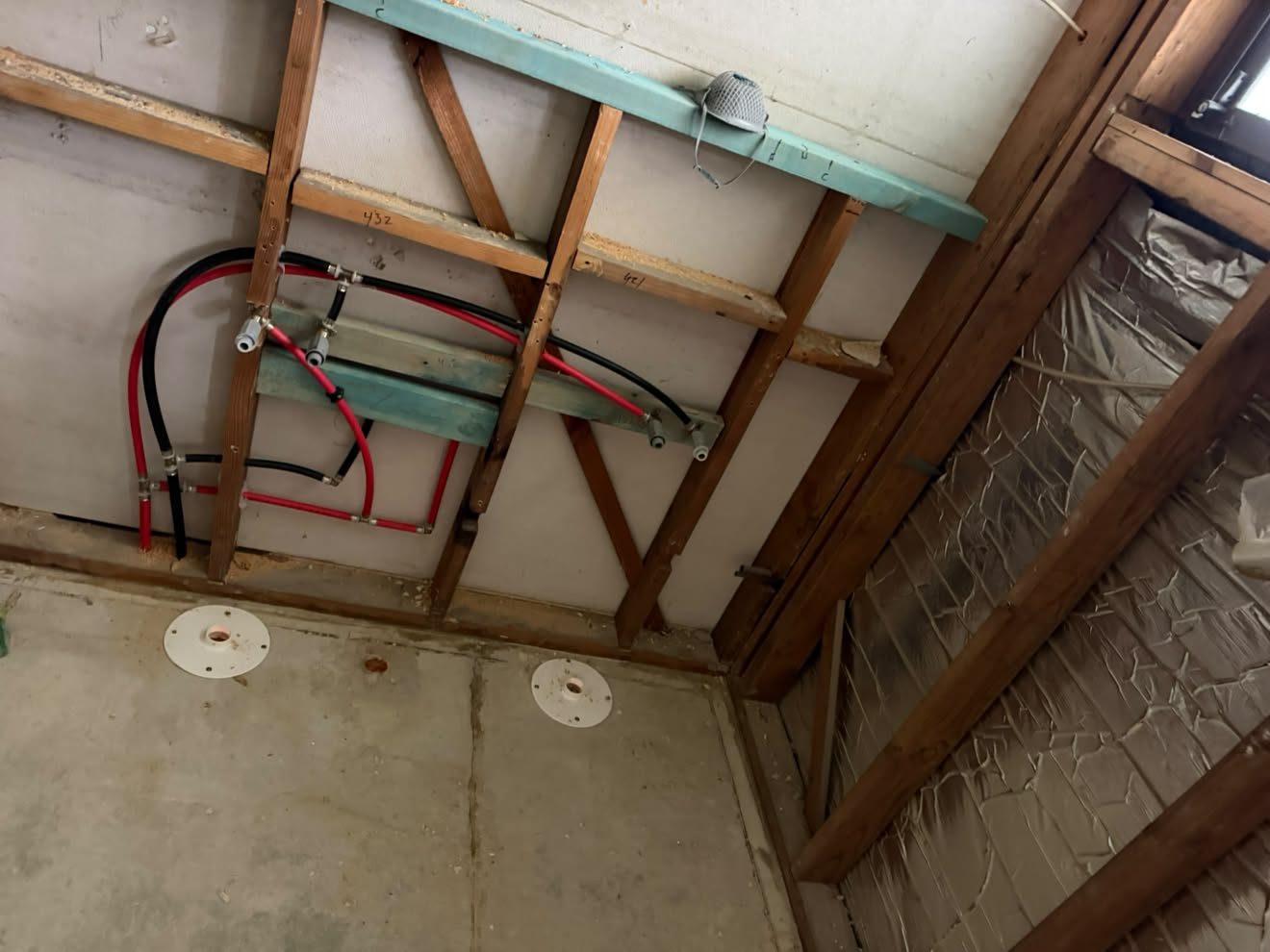 Hot and cold set out on noggins, floor waste and pan connector positioned.