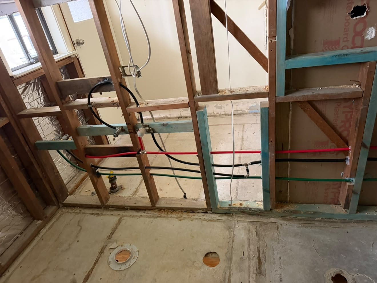 Bathroom rough-in: PEX through the frame, pan collar and floor waste core-holed into the slab.