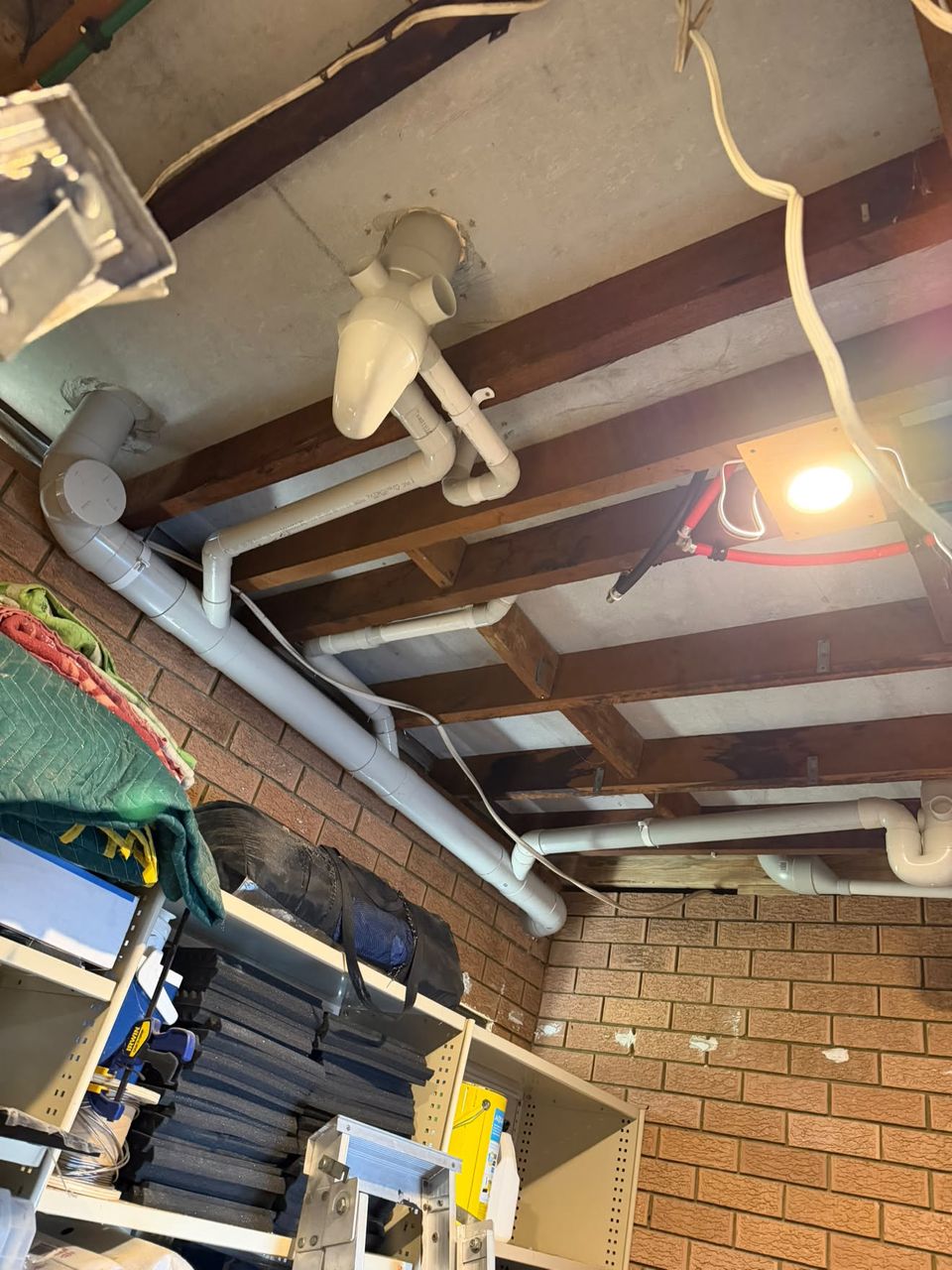 Sanitary drainage and vent stack run under the floor.