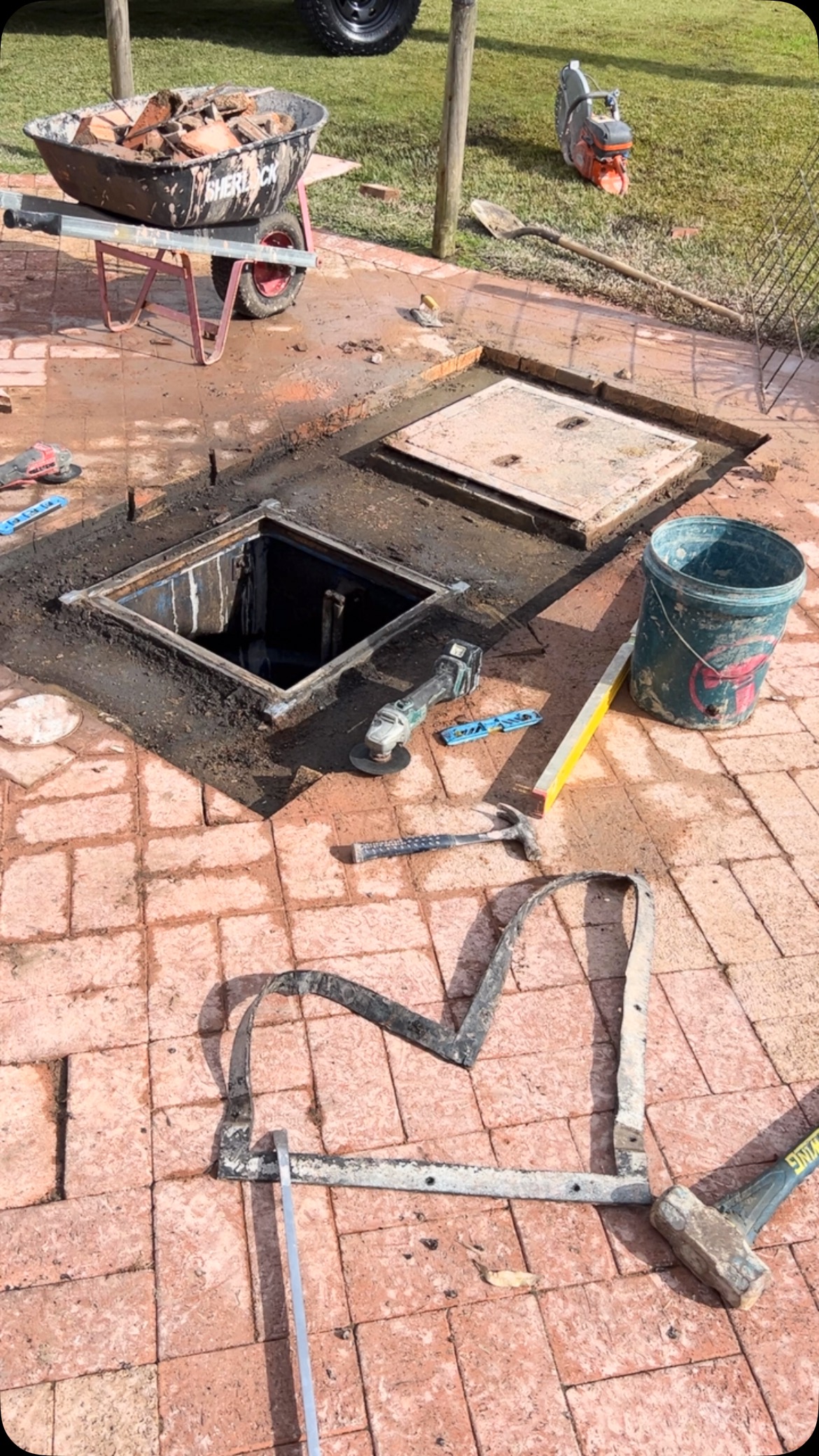 Raising a grease-trap cover in brick paving, Soldiers Beach